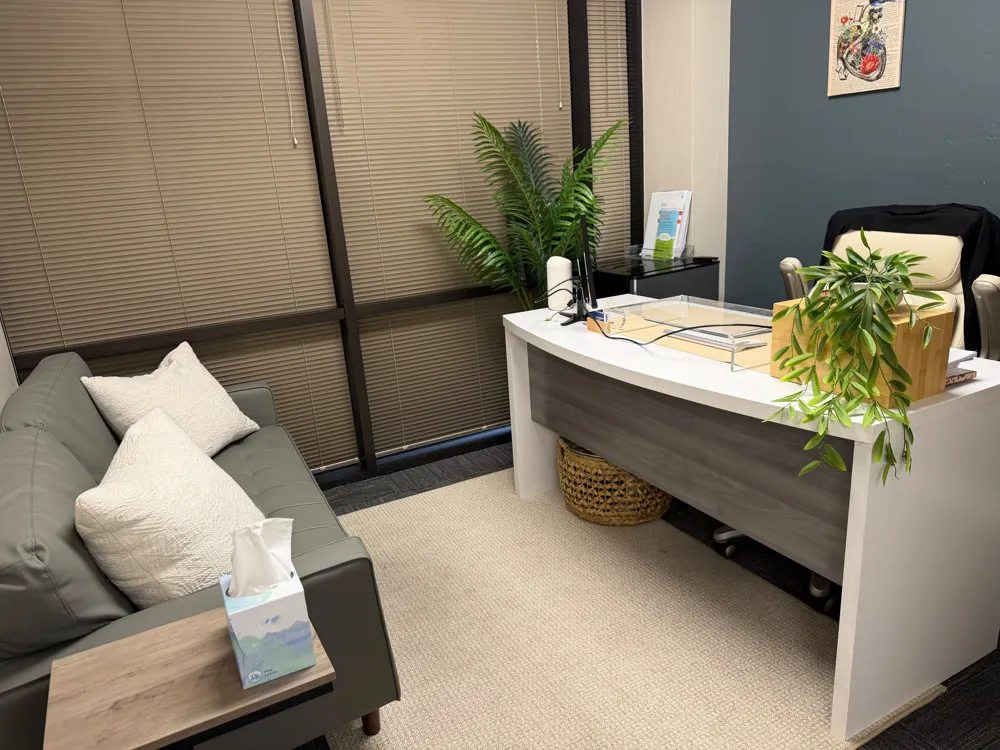 Desk and sofa in a consultation room at our Phoenix office